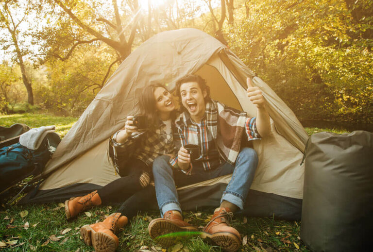 Camping Young Couple Sitting 2 person backpacking tent in the forest