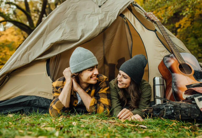 Young Couple Camping in the forest with a tent