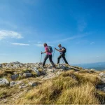 Couple hiking on nanos plateau in slovenia